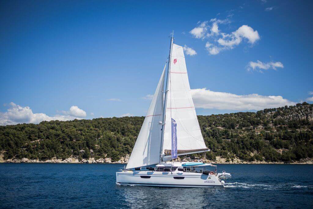 yacht sailing near the coastline